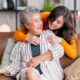 san diego naturopathic doctors candid daughter hugging grandmother on couch