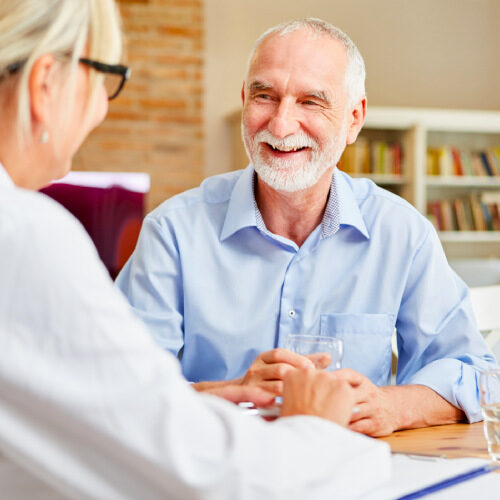 san diego naturopathic doctors elderly man smiling at clinic with health care worker