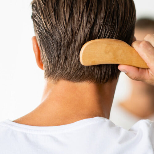 san diego naturopathic doctors man combing his back hair with comb