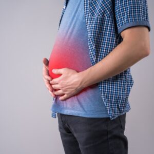 san diego naturopathic doctors red glow of man holding bloated belly