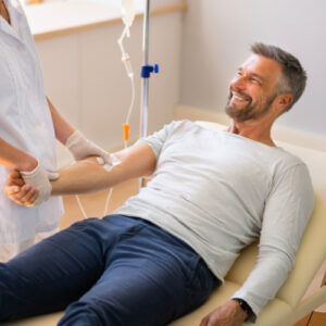 san diego naturopathic doctors smiling man sitting receving iv therapy