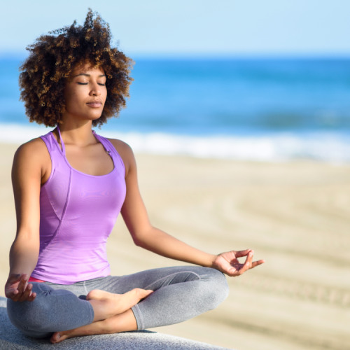 san diego naturopathic doctors woman meditating sitting infront beach background