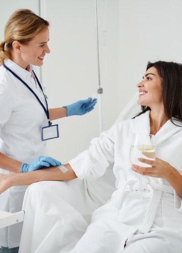 san diego naturopathic doctors woman sitting smiling receiving iv therapy