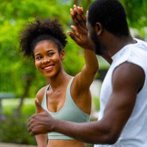 san diego naturopathic doctors athlethic couple high fiving in park exercising