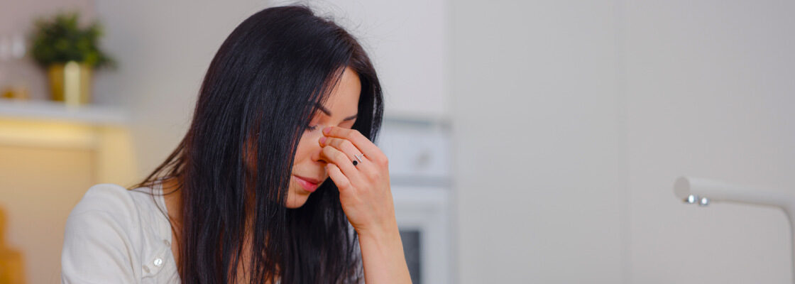 san diego naturopathic doctors exhausted woman tired hand rubbing face