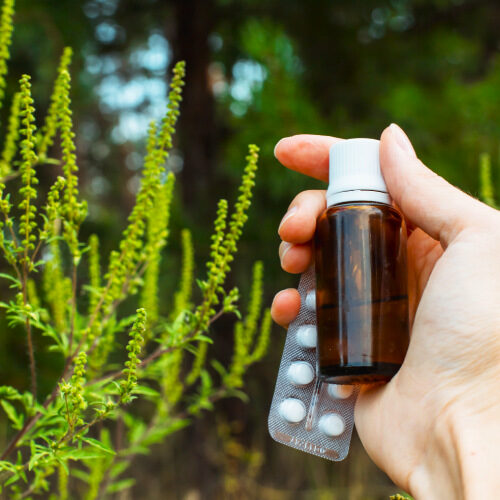 san diego naturopathic doctors hand holding anti allergies medication out doors