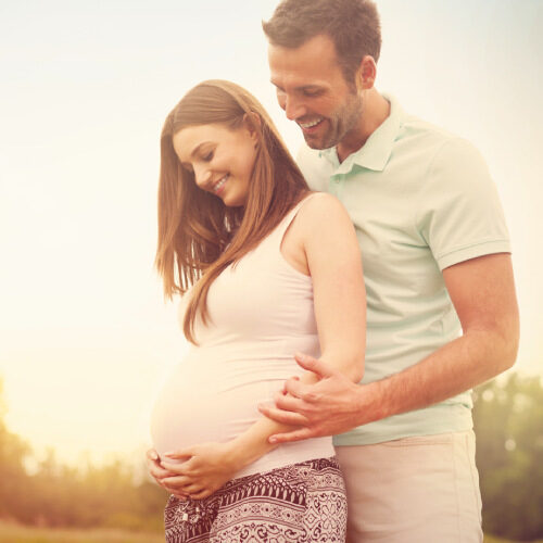 san diego naturopathic doctors smiling couple embracing pregnant woman