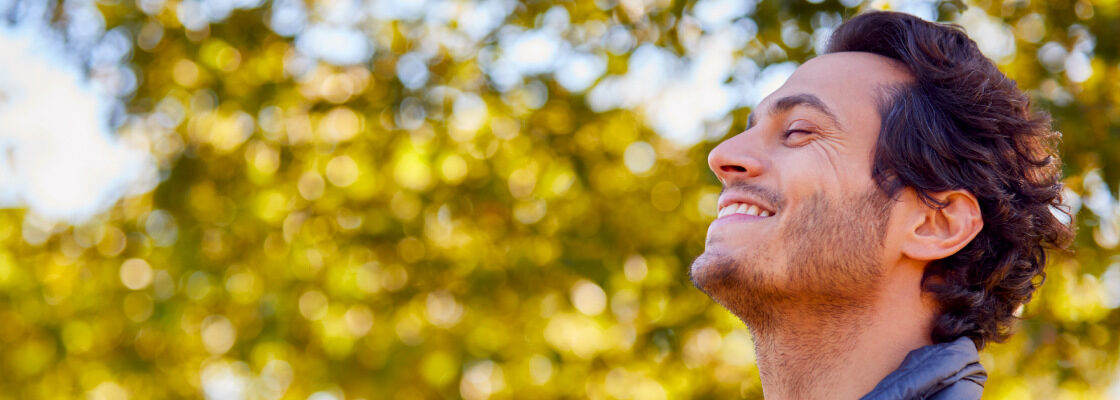 san diego naturopathic doctors smiling man sigh of relief in park