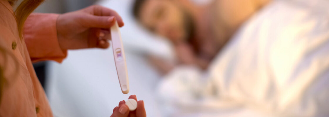 san diego naturopathic doctors woman checking pregnancy test in bedroom