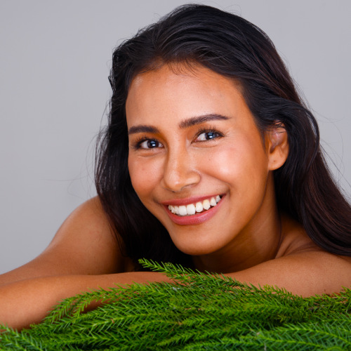 san diego naturopathic doctors woman smiling posing alongside green leaves