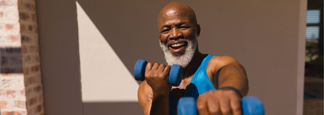 san diego naturopathic doctors athletic elderly man smiling with blue dumbbells